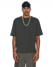 model wearing clear resin Cuban link necklace draped over a black tee