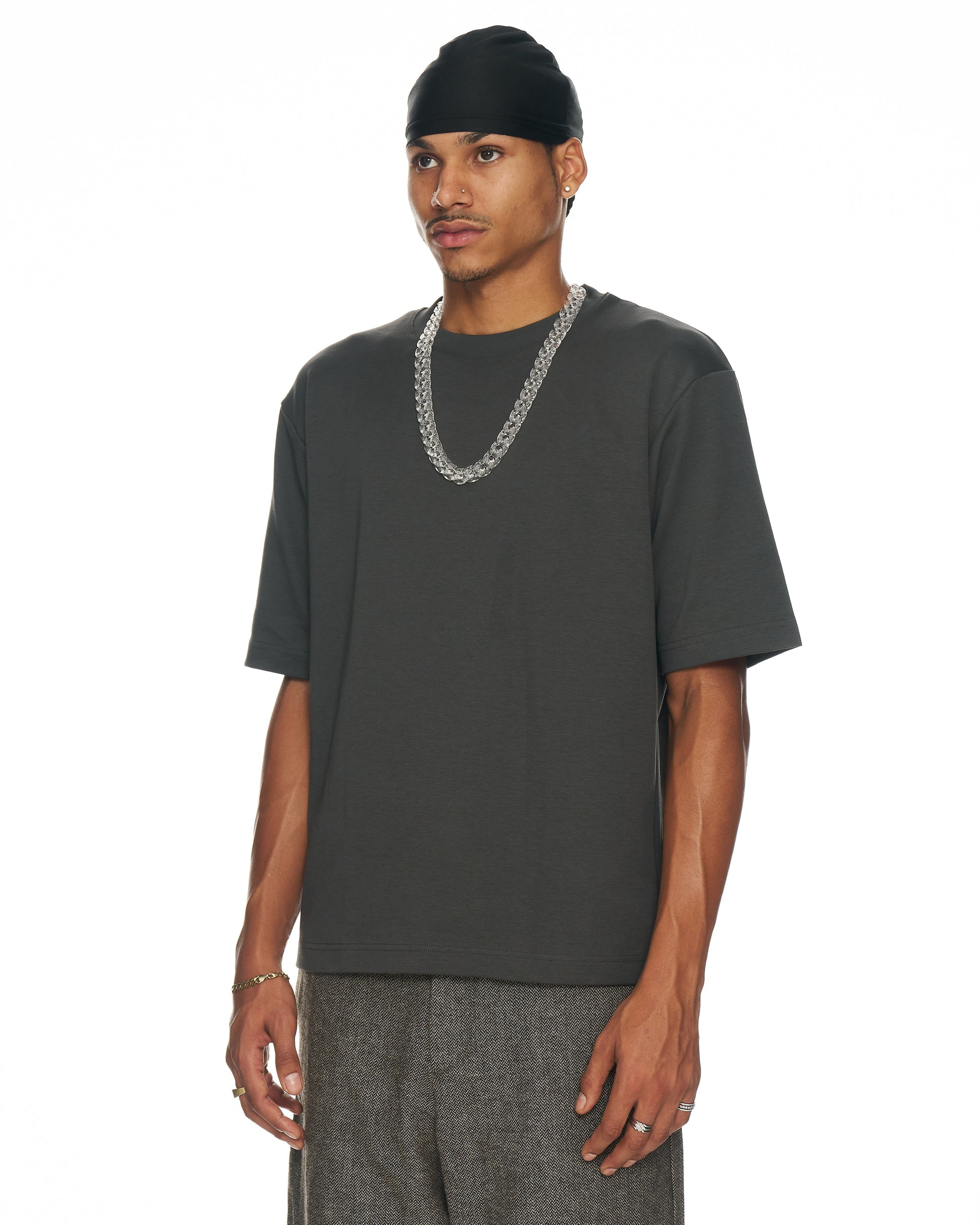 side view model with clear Cuban link resin chain necklace across the shoulder line