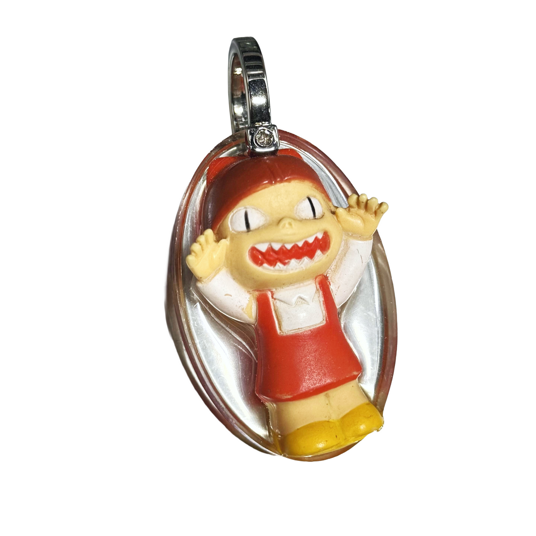 Keychain with cartoon character in red dress and yellow shoes on a white background